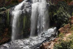 Waterfall with rocks and trees photo