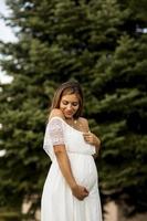 Young pregnant woman at the forest photo