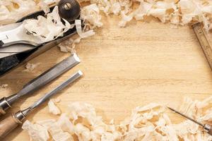 Carpentry or woodworking background with copy space Old carpentry tools and wood shavings on a workbench photo
