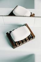 A hard soap over a soap dish in a white toilet photo