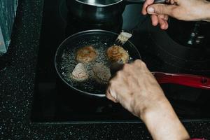 Frying meatballs in the kitchen