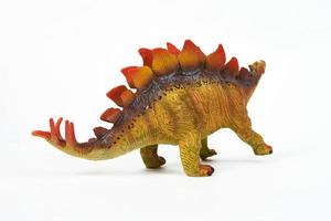 Juguete de goma de dinosaurio aislado en blanco foto