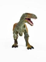 Tyrannosaur rubber toy isolated on white photo