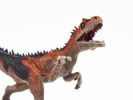 Juguete de goma de dinosaurio saurophaganax aislado en blanco foto