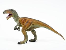 Tyrannosaur rubber toy isolated on white photo
