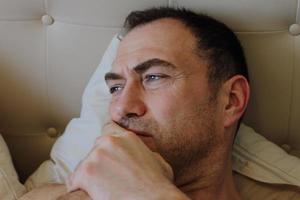 Man staying in bed with toothache