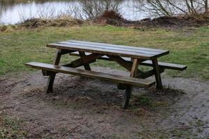 wooden picnic bench in the rain photo
