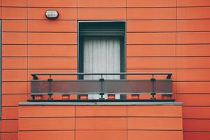 window on the red facade of the house photo