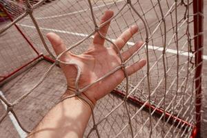 hand grabbing a rope net photo