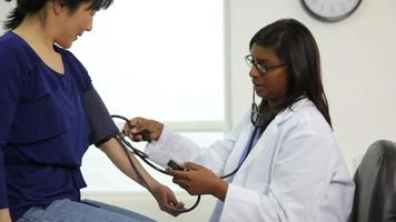 Doctor checking patient's blood pressure video