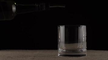 Whiskey is poured into a glass video