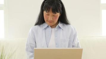 mogen asiatisk kvinna med bärbar dator