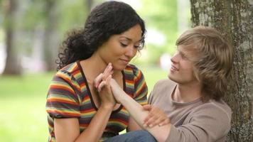 Portrait of couple sitting together by tree video