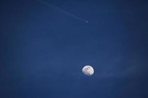 White moon under clear blue sky photo