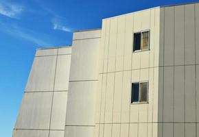 Gray building with two windows photo