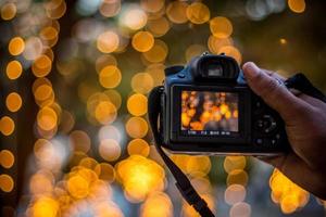 DSLR Camera on Bokeh Background Black DSLR Camera With Bokeh Lights Photo and Camera City Lights Bokeh