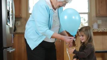 Great grandmother in kitchen with young girl video