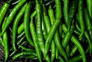 Fresh Green chili pile background Top view photo