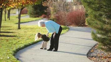 Great grandmother walking with young girl video