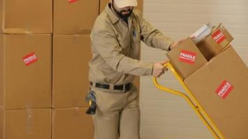 Delivery man delivers packages through warehouse video