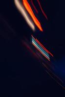 multicolored defocused light on the street at night photo