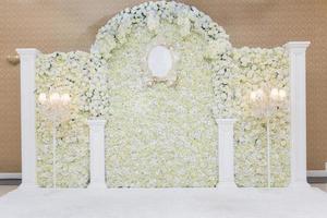 Beautiful white wedding backdrop with flower photo