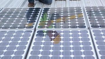 Contractor installing solar panels on industrial rooftop, portrait video