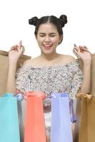 Attractive shopper woman holding shopping bags isolated on white background photo