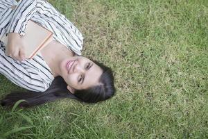 Attractive woman reading a book in the park photo