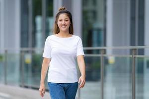 Woman in white t shirt and blue jeans photo