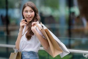 Outdoors portrait of Happy woman holding shopping bags and smiling face
