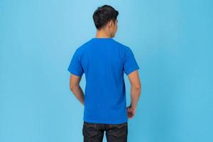 Young man in blue t shirt isolated on blue background photo