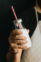 Waiter holding a milkshake close-up with copy space photo