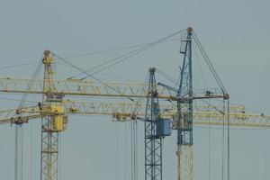 construction cranes against the sky yellow building crane blue crane photo