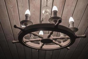 lamp with bulbs chandelier in the form of a wheel wooden ceiling photo