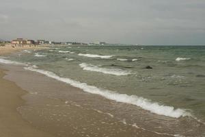 turquoise waves of a raging ocean on the summer beach photo