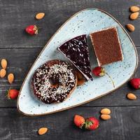 Beautiful doughnut, chocolate cake, and tiramisu, top view photo