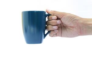 Right hand holding blue coffee cup on white background photo