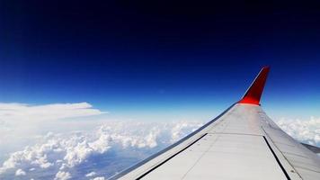 Aircraft wing on blue sky background photo