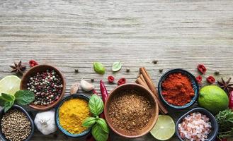 A selection of various colorful spices on a wooden table in bowls 2510533  Stock Photo at Vecteezy