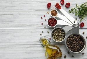 Various spices on white wooden background, top view photo