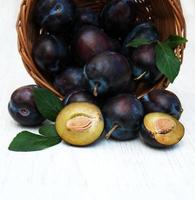 Sweet plums on a wooden background photo