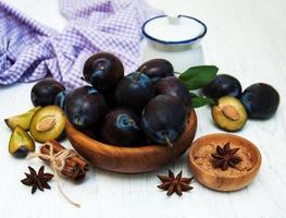 Sweet plums on a wooden background photo