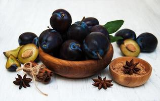 Sweet plums on a wooden background photo