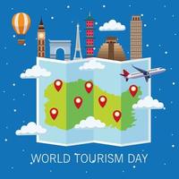 world tourism day lettering celebration with paper map and monuments vector