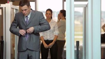 Businessman is inspected by airport security video