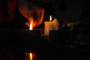 Hand lighting candle photo