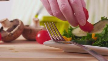 Making fresh healthy salad, closeup video