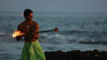 Hawaiian fire knife dancer performs, slow motion video