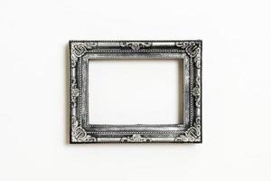 Empty picture frame on white wall background with copy space photo